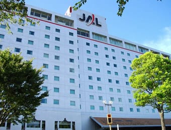 a large white building with a red and white sign on top of it