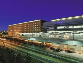 a large building that has a lot of cars in front of it